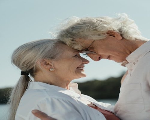 Elderly couple smiling outdoors